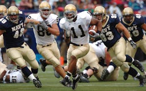 Players in action during a competitive American football game outdoors.